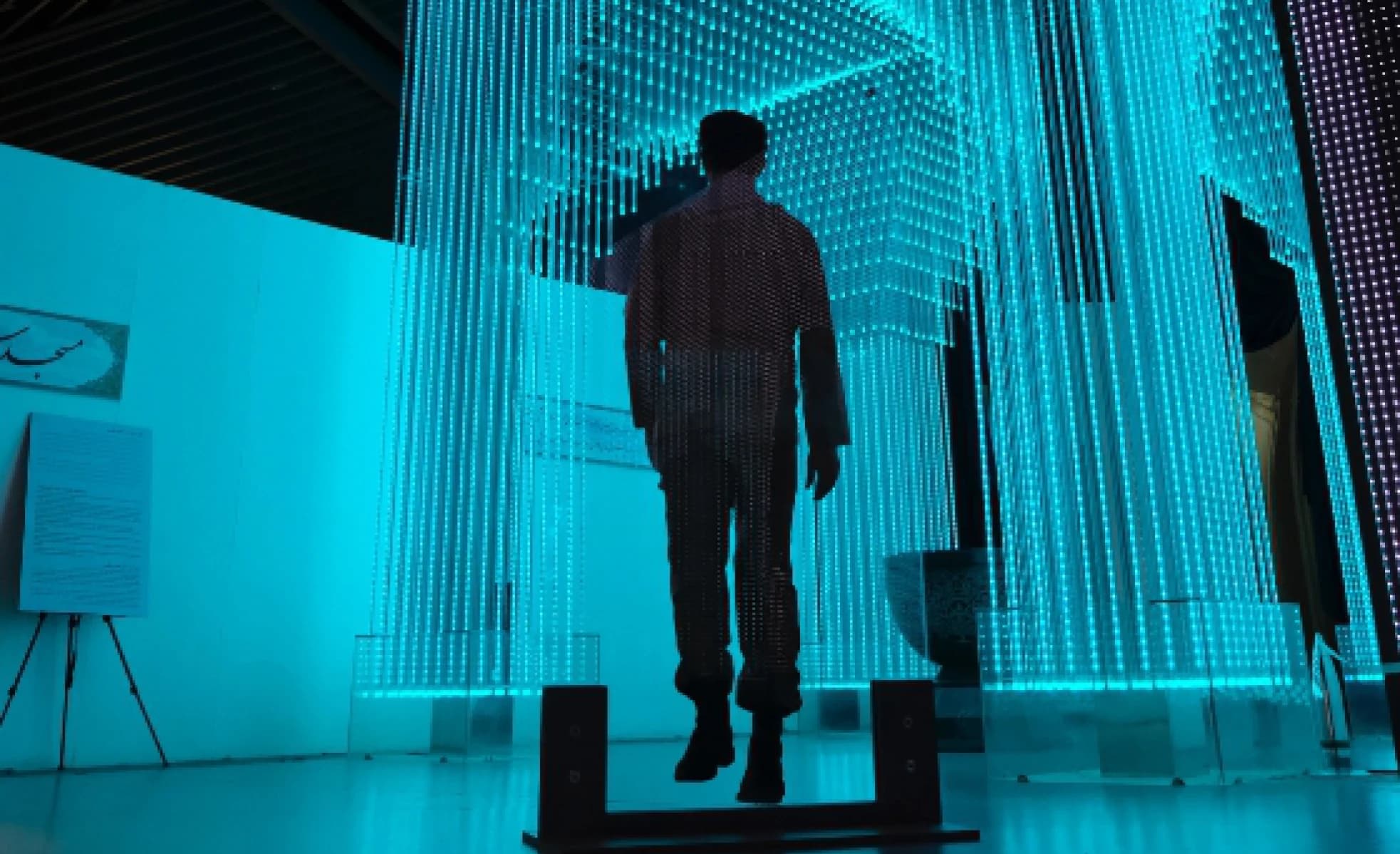 Developer wearing a cap looks at code and log lines on a screen in a dark room, image accompanying the Log4Shell vulnerability